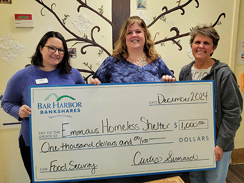 Bar Harbor Bank & Trust employees present a donation to Emmaus Homeless Shelter.