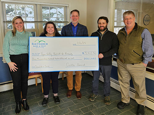 Employees present a donation to Upper Valley Habitat for Humanity