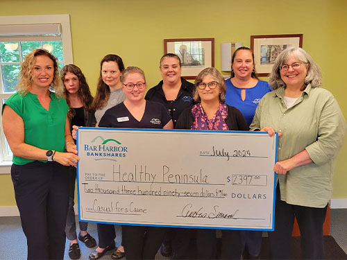 Employees present a donation to Healthy Peninsula