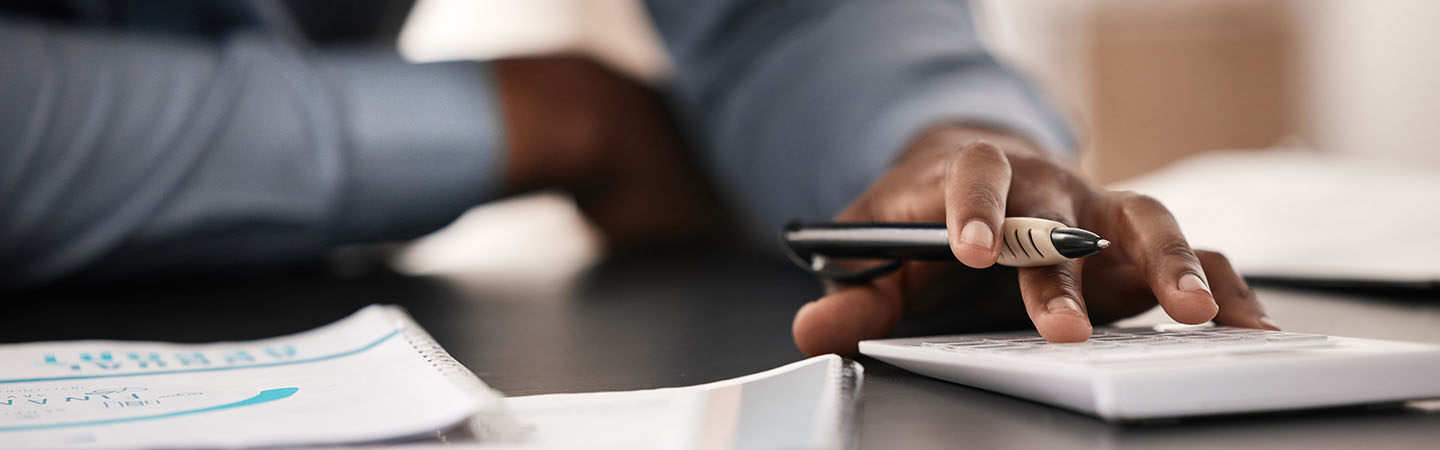 Man entering numbers on a calculator