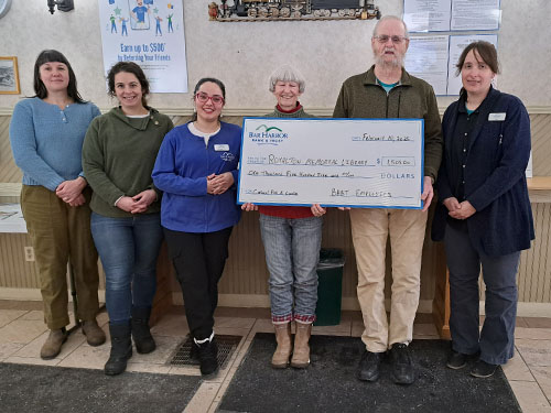 Employees present a donation to Royalton Memorial Library