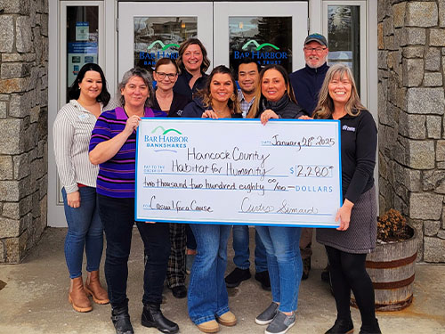 Employees present a donation to Hancock County Habitat for Humanity