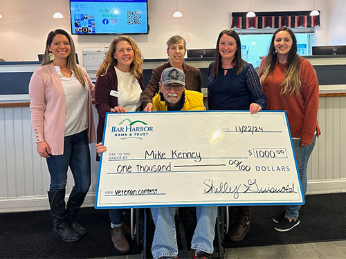 Bar Harbor Bank & Trust employees present Mike Kenney, winner of the Bank’s Honor a Veteran Contest, with a check. 