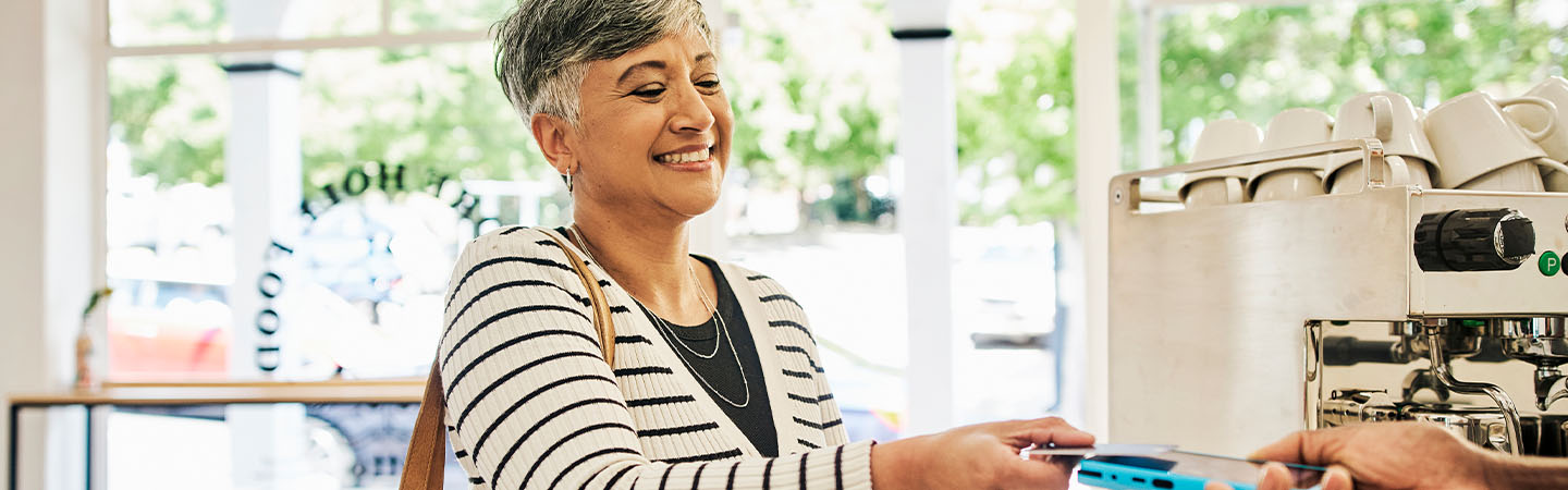 Woman paying for coffee with a credit card