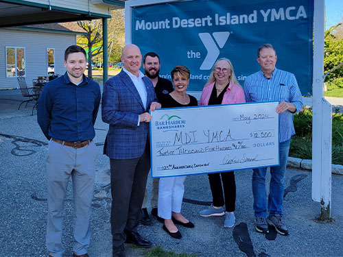 BHBT employees present a donation to Mount Desert Island YMCA