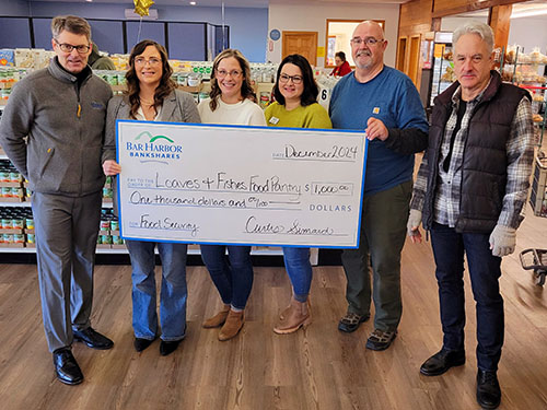 Bar Harbor Bank & Trust employees present a donation to Loaves & Fishes Food Pantry.