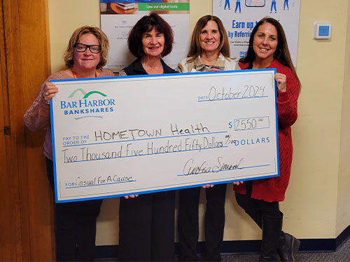 BHBT employees present a donation to Hometown Health Center